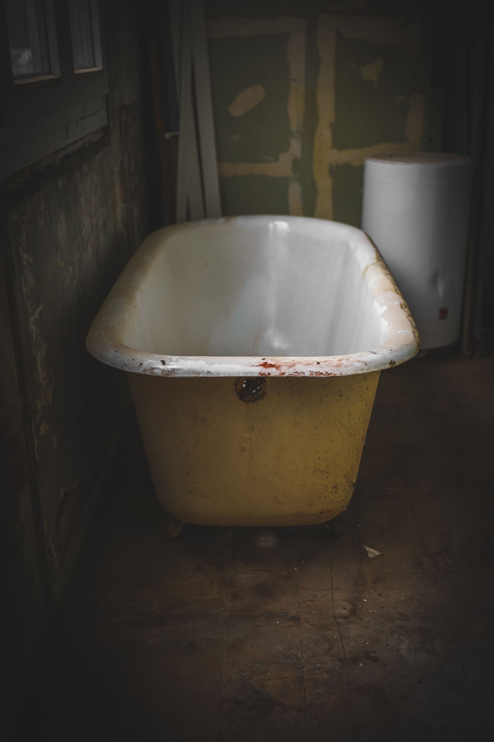 photo of an old bathtub in a dilapidated house