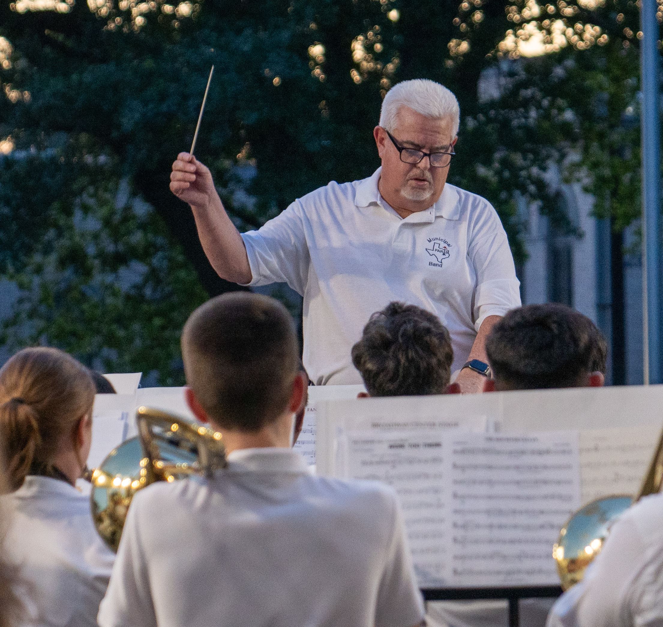 Picture of Joe Watson directing the Paris Municipal Band on the Peristyle in Bywaters Park